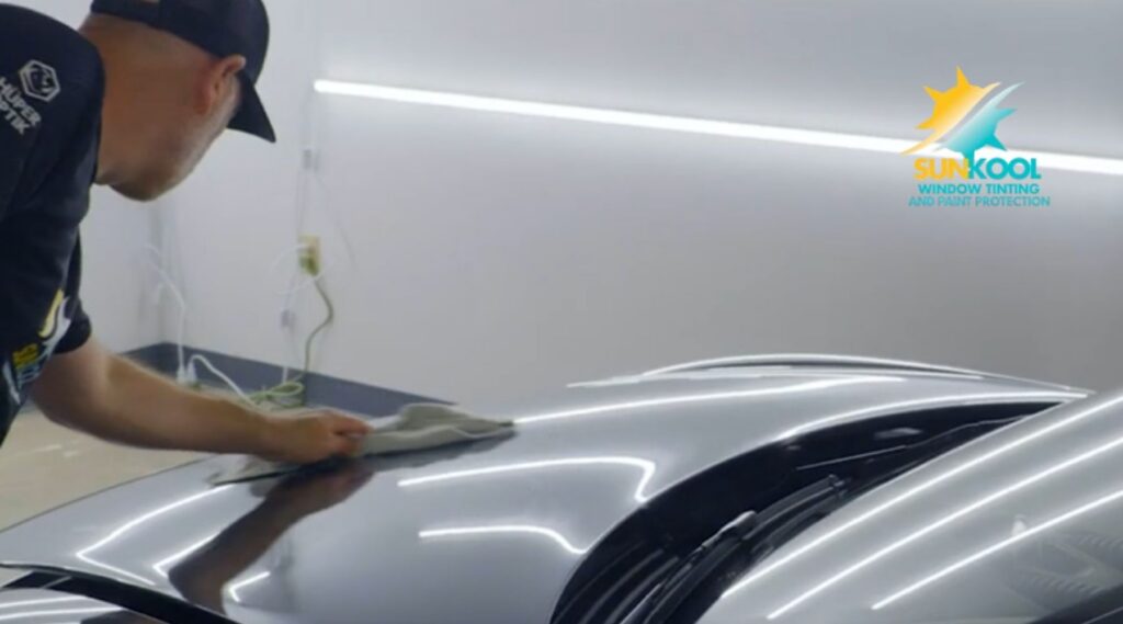 Sun-Kool technician cleaning a vehicle hood before paint protection film installation in Hickory, NC