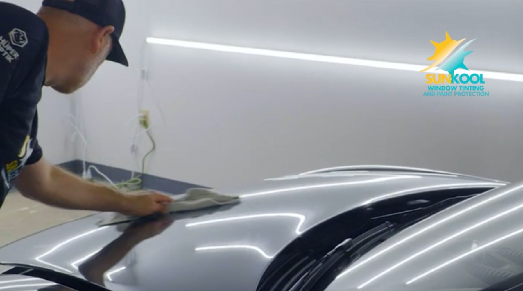 Sun-Kool technician cleaning a vehicle hood before paint protection film installation in Hickory, NC