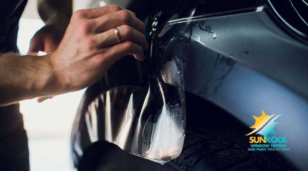 Technician applying paint protection film to a vehicle at Sun-Kool in Hickory, NC.